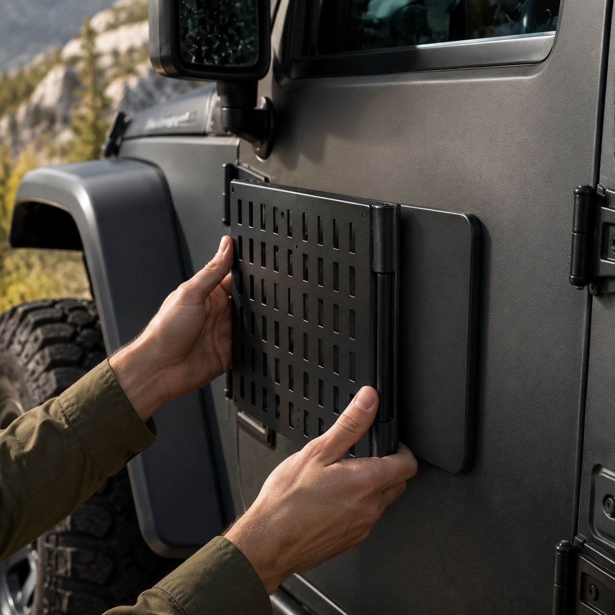 Hands mounting the folded ROVOLT MAGDECK to a clean steel vehicle panel
